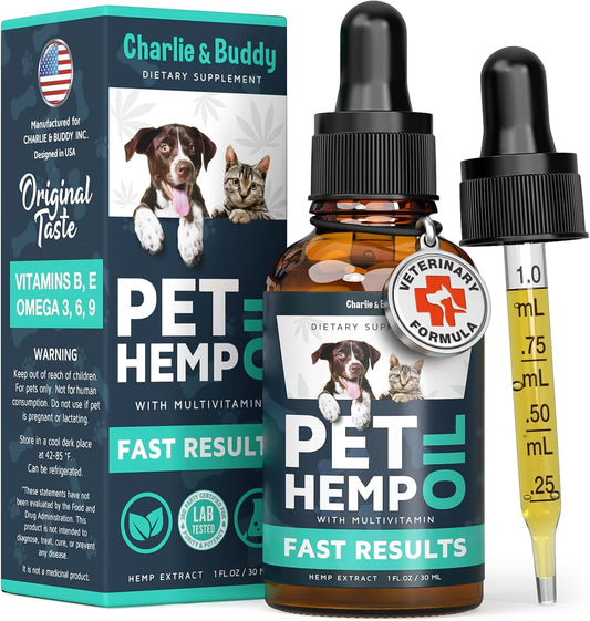 A bottle and dropper of Charlie & Buddy Hemp Oil for Dogs and Cats, labeled for anxiety, pain, stress, sleep issues, and arthritis relief with a cat and dog on the label. The box beside it features supplement info.